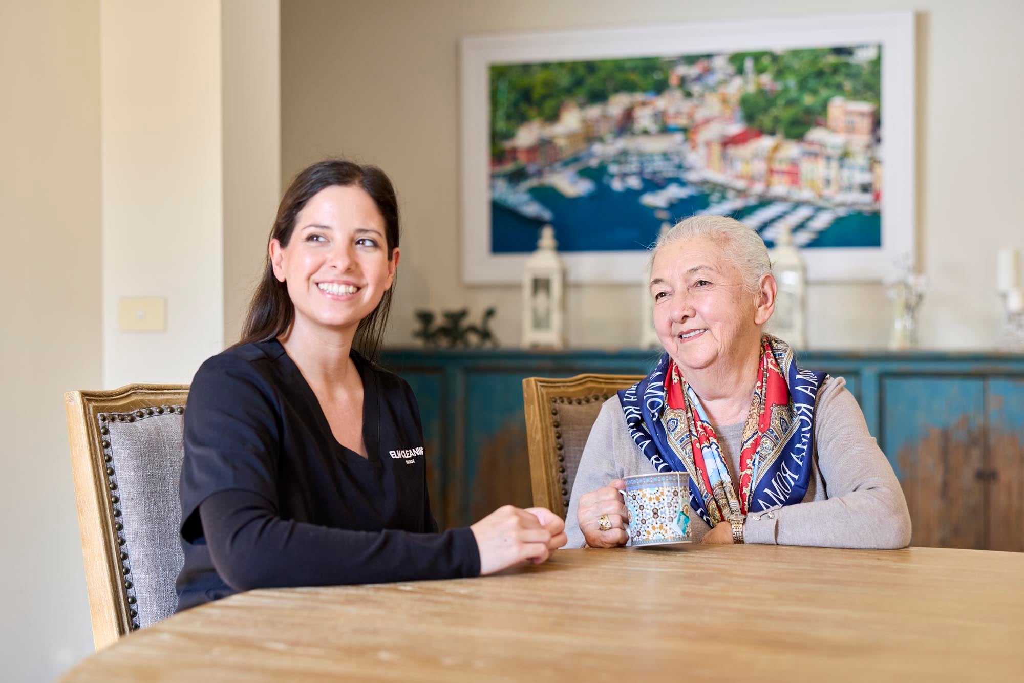 ELM cleaner sitting with an elderly client